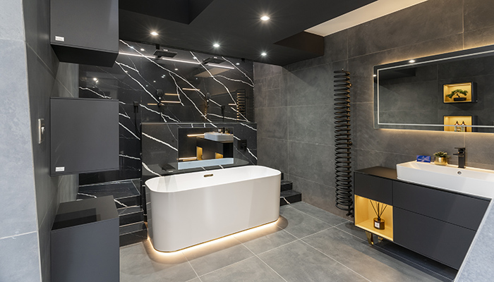 This display features a double walk-in raised shower area with Silestone wall cladding, Villeroy & Boch bath, mirror, vanity unit and light boxes from the Finion collection, an Aqua Vision recessed TV and spiral Bisque radiator. Brassware from Hansgrohe’s Metropol collection completes the look