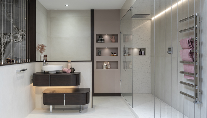 This Burgbad Lavo2.0 vanity unit in Mocca Dark Oak has an offset elevated mineral cast wash basin. The bespoke Matki shower enclosure is made from 10mm glass and is paired with a Hansgrohe Axor recessed rainhead showerhead