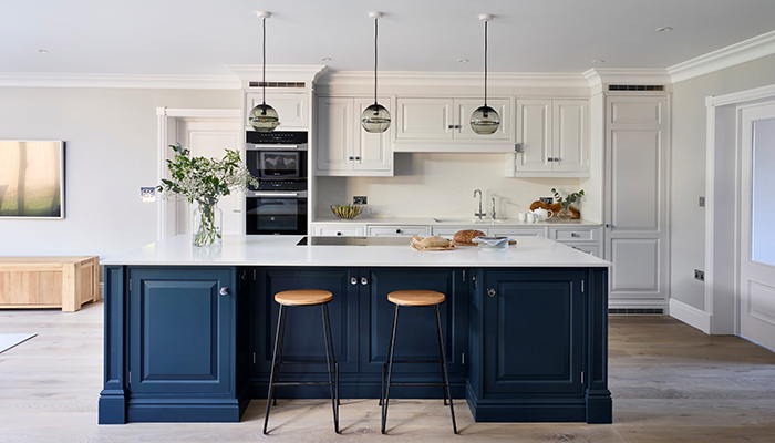 The trio of glass pendant lights from John Lewis draw the eye to the island, which houses a Novy downdraft induction hob, in this new build property’s open-plan kitchen, designed and made by Simon Taylor Furniture