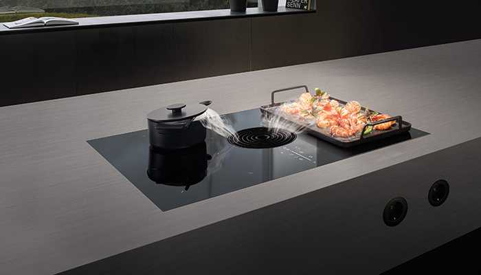 The new Bora M Pure cooktop extractor has a bridging function that connects the two induction zones on the right to create a large zone that can heat the Bora grill pan 