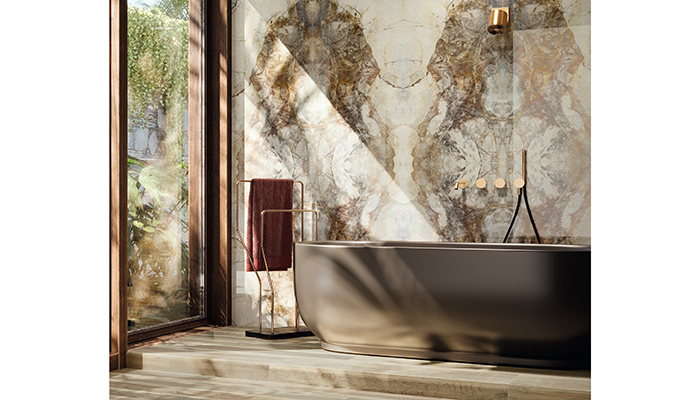 These Mirrored Gold marble-effect porcelain tiles from Lapicida provide a stunning backdrop in this indulgent bathroom, replicating the variations and beauty of natural marble for an authentic look, while offering consumers the practical benefits of porcelain