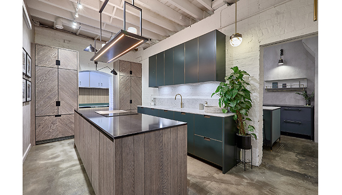 Broseley range kitchen in Stained Oak and Farrow & Ball Studio Green with patinated brass trim and handles