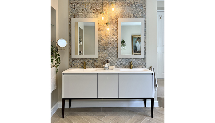 This award-winning master en suite, inspired by the client’s piece of art, was meticulously designed by Welsh retailer The Tap End. It features the double Alnwick vanity unit in pale smoke from Burbidge & Son’s Bathroom Furniture Makers, Tappeto tiles from Lapicida, and brushed brass taps from Coalbrook. Summit LED pendants from HiB complete the look