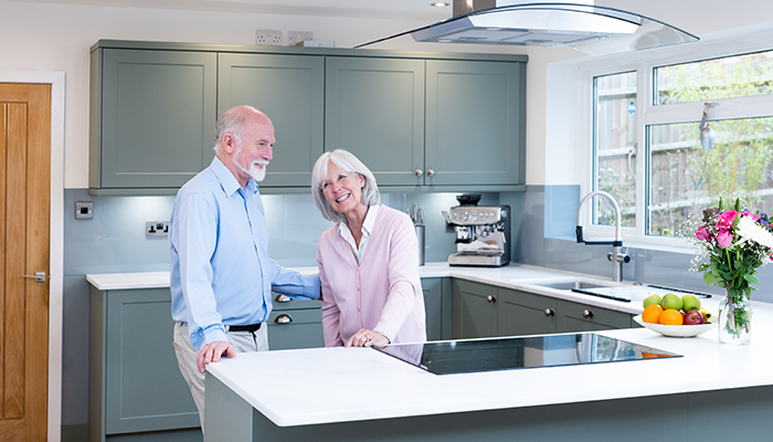 Two happy customers in their Dream Doors kitchen complete with Blanco tap