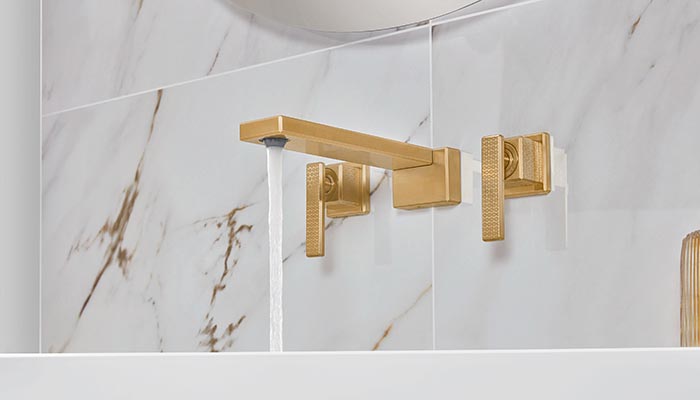 Wall-mounted brassware can add a luxurious touch to spa-style bathrooms, particularly when finished in brushed gold, as demonstrated by Villeroy & Boch’s Mettlach three-hole basin mixer