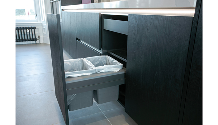 In-cupboard bins providing waste management systems can help consumers maintain a clean and sustainable kitchen. Seen here in Sherwood Black, Rotpunkt’s Xerox furniture houses a discreet two-in-one bin to make light work of sorting and storing recycling and waste