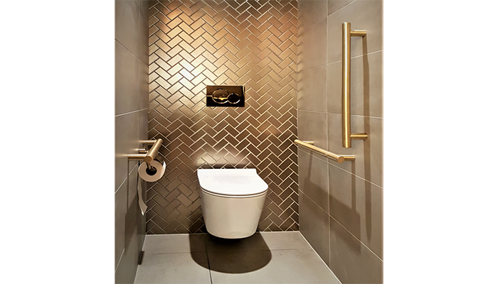 Finished in brushed brass, the golden grab rails from Fitzroy of London’s Gosfield range were a perfect match with the shimmering wall tiles in London’s Hard Rock Hotel