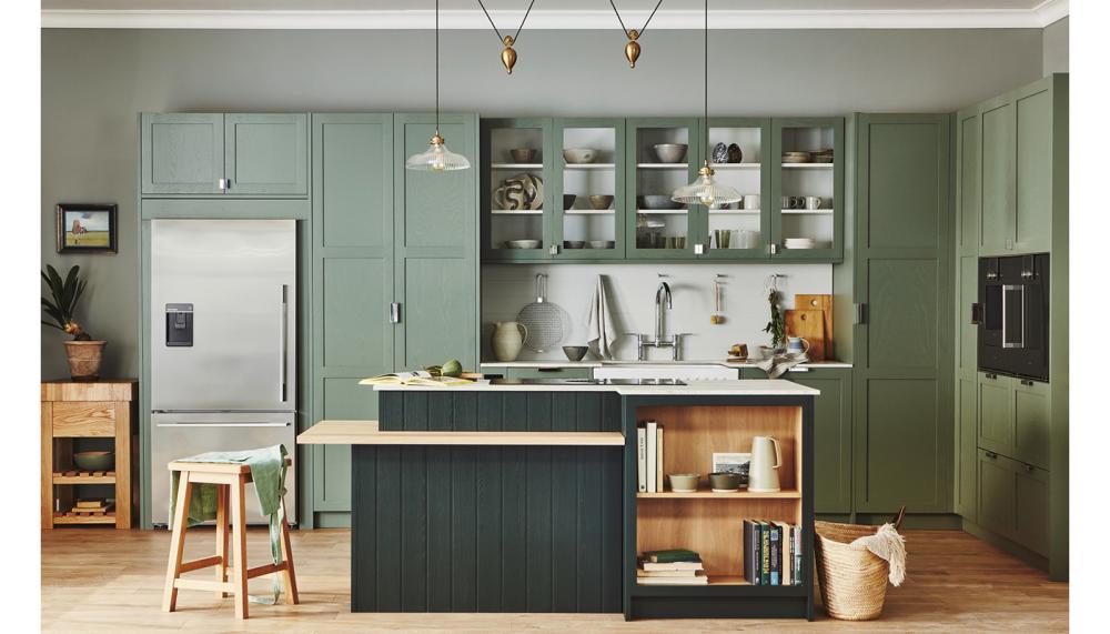 Naked Kitchens' Saint Giles kitchen is painted in the subtle shade of Misted Fen, with the island in moodier tone Sandringham Pine for a soothing space that's nonetheless packed with personality