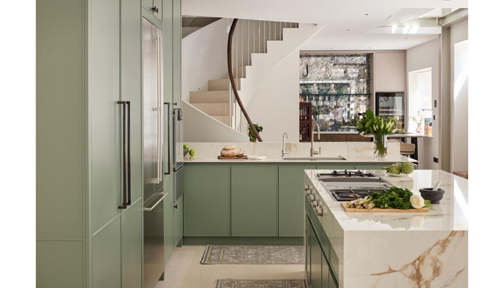 This design by Sheraton Interiors pairs a soft green shade with richly veined surfaces