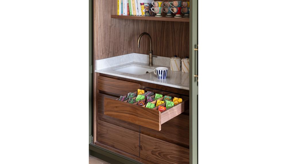This bespoke tea station designed by Searle & Taylor features pocket doors that open into side recesses and matching drawer fronts. Also featured is a Lincoln undermount sink with a patinated brass Quooker 3-in-1 boiling water tap. Photo: Paul Craig)