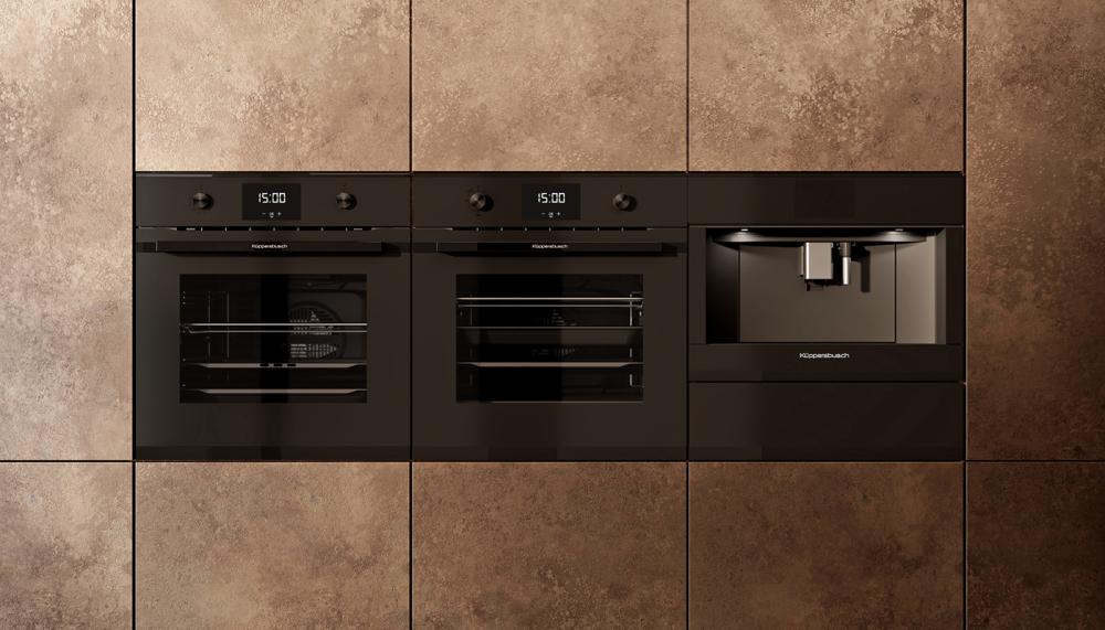 Shown here alongside its compact coffee maker, the K&uuml;ppersbusch Matt Black collection warming drawer offers variable temperatures from 30&ordm;C to 80&ordm;C. It&rsquo;s suitable for for keeping food warm, defrosting, low temperature cooking, and warming dishes, and has a capacity of up to 20 plates with 28cm diameter