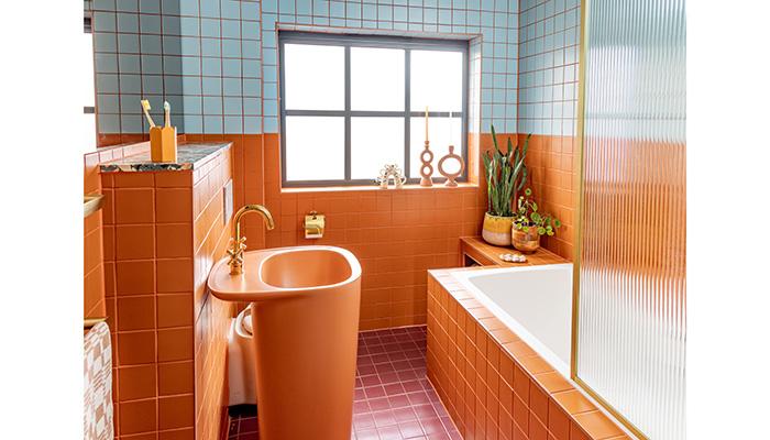 The Plural freestanding washbasin, designed by Terri Pecora for VitrA, in Matt Terra Rossa, stars in interior stylist Emma Jane Palin's vibrant bathroom. Also featured are Terracotta and Blue tiles from the VitrA Pro Colour range and gold Origin brassware – Photographer: Sam Roberts