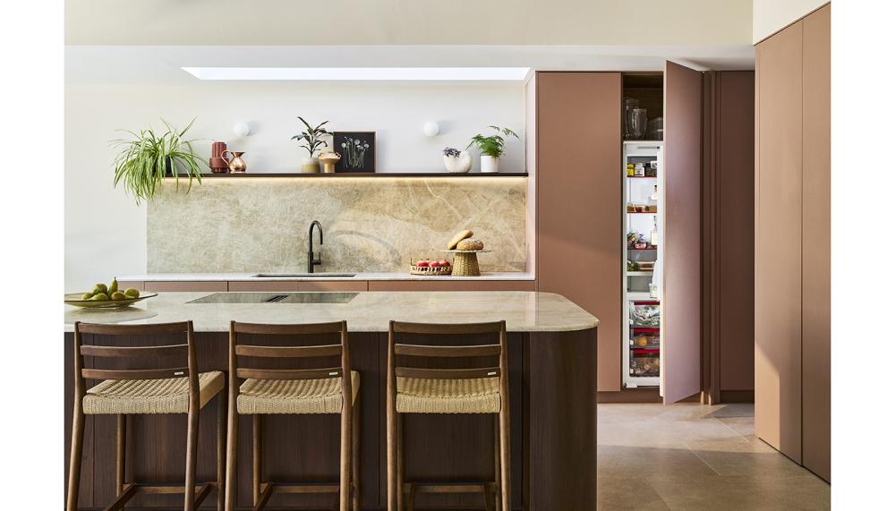 This knock-to-open NEFF fridge-freezer is shown in the Grove Park design by Naked Kitchens – a scheme that while warm and welcoming conceals all the working elements to maintain a sleek finish