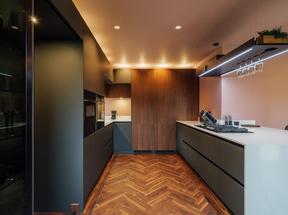 Layered lighting in a scheme by West Midlands-based The Gallery fitted kitchens, showcasing Rotpunkt's handleless furniture