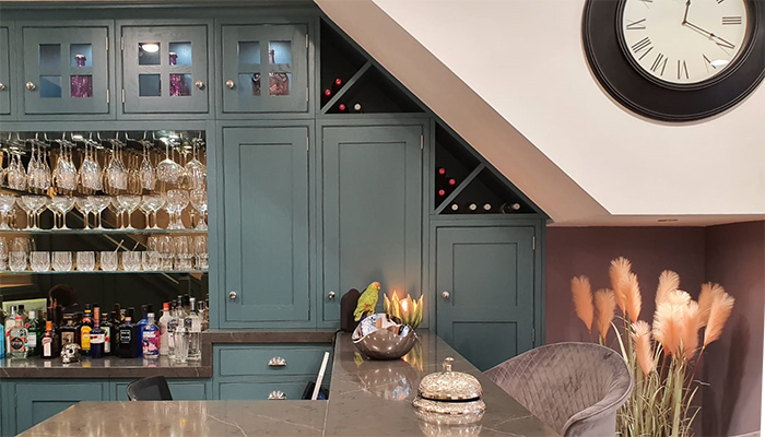 These wine racks by Brandt Design make inventive use of an awkwardly shaped area under some stairs as part of a dedicated bar area