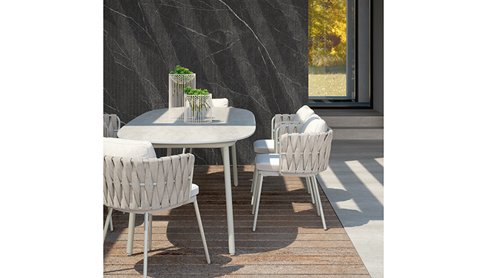 Outdoor dining area featuring Laminam Diamond Calacatta Black wall cladding