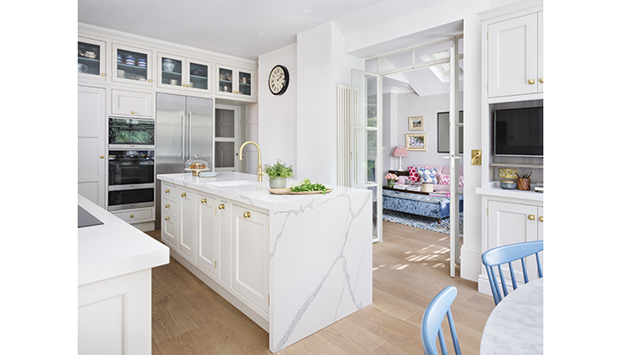 Martin Moore’s Classic Shaker-style kitchen collection has been hand-painted in Chalk, with contrasting veined worktop, brass tap, door handles and oak panelled flooring bringing warmth to the space