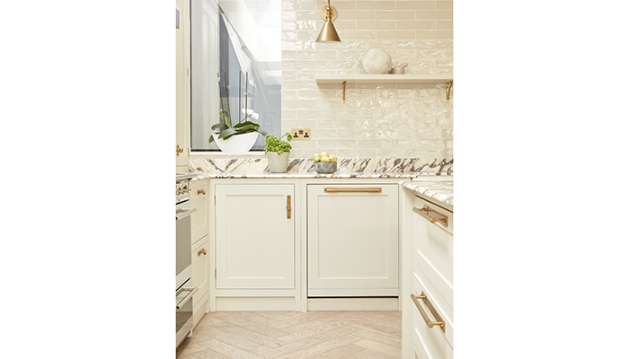 Olive & Barr designed this Shaker-style kitchen with cabinetry hand-painted in Portland Stone by Little Greene, shown with Armac Martin handles and contrasting Arabescato marble worktop – a perfect example of how a paler off-white palette can work beautifully in a smaller kitchen