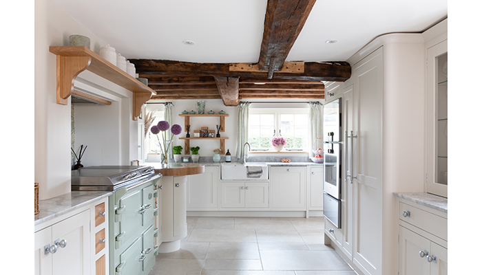A Shaker kitchen designed by Darren Taylor, MD of Searle & Taylor, uses a highly pigmented pale taupe to reflect natural light to contrast with the timber features along with Armac Martin satin chrome handles and an Everhot range cooker in Sage Green adds subtle colour to the space Photo: Paul Craig