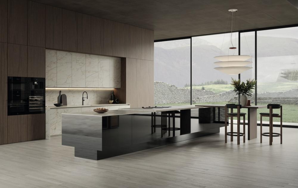 This kitchen by Snaidero features an island with Elementi doors in Ossidiana Mirrored PVD steel and Macchia Vecchia Crystal ceramic worktop. Tall units with Elementi doors in ribbed aluminum American Walnut wood. Base units and wall units with Elementi door in Macchia Vecchia Crystal ceramic, in continuity with the worktop and wall panel