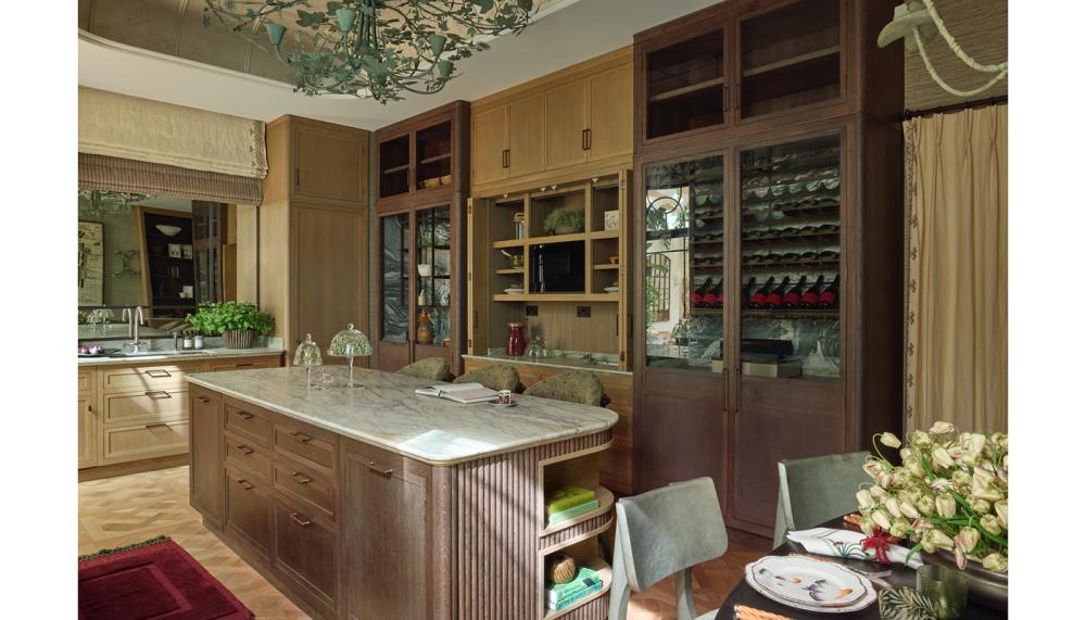 Designed as both a functional workspace and social hub, the kitchen layout unfolds as an integrated cooking, dining, and living environment