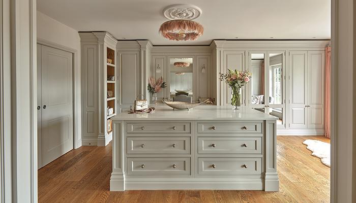This custom-designed dressing-room from Tom Howley’s Devine Collection integrates open and closed storage, optimising the room’s vertical space. Open shelving has been strategically placed around the sliding bathroom doors, providing convenient access and display space for bags and shoes
