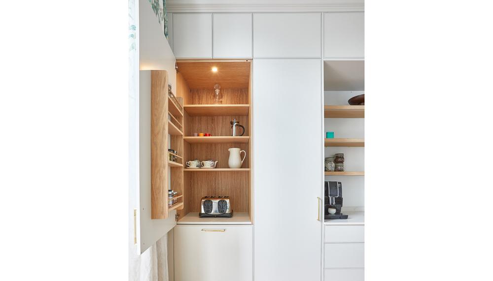 This bespoke breakfast pantry designed by Kitchens by Holloways features drawers for storing cereals, coffee pods and teas and a dedicated worktop area for secondary appliances such as toasters and coffee machines with electrical sockets to ensure practicality