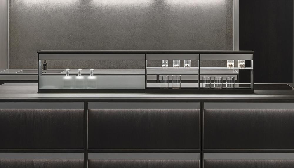 The new ALVOLO kitchen from Poggenpohl features a retractable storage system that can be fully lowered into the kitchen island and raised at the touch of a button