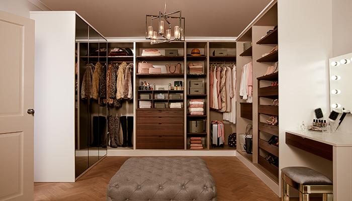 This impressive U-shaped dressing-room from PWS includes rows of open shelving, hanging space and mirrored wardrobes for a glamorous look with a Porter Matt White finish and walnut interiors