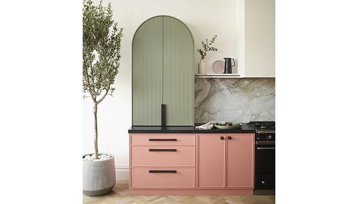Taking centre stage in this kitchen is a bespoke curved and ribbed tall cupboard 